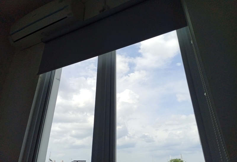 Motorized window blinds are partially lowered on large windows in Tucson, AZ