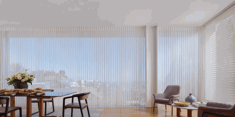 Dining room with table and chairs featuring light‑filtering sheer shades over a window in Tucson.